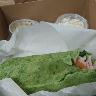 Mediterranean wrap with two portion sizes of coleslaw and pasta salad