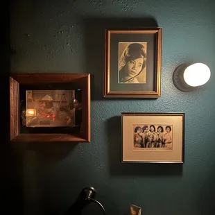 a bathroom with a sink and pictures on the wall