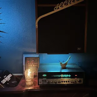 a guitar amp and a candle