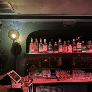 a shelf full of liquor bottles