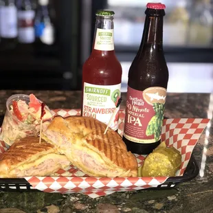 a sandwich and two bottles of beer