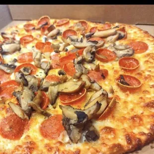 a pizza with pepperoni and mushrooms