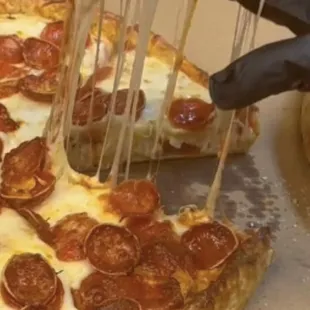 a slice being taken out of a pizza