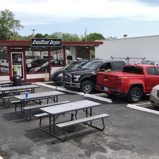 Store front and picnic tables.  No indoor seating. Additional parking in the rear.