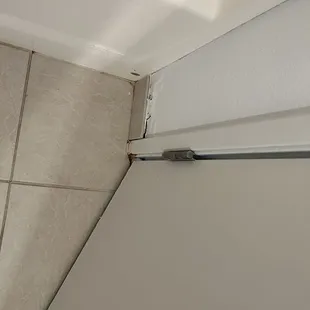 Loose tile with mold behind it.