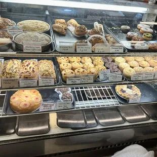 Display case of breads, rolls, muffins, donuts, etc.