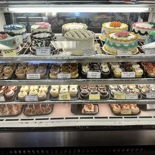 Display case of cakes and cupcakes