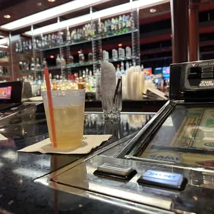 a pinball machine and a glass of beer