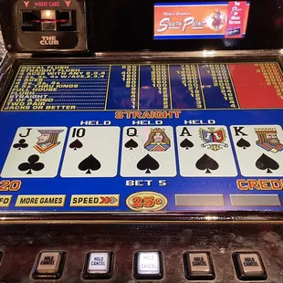 a slot machine with four of a kind playing cards