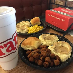 two plates of food and a cup of coffee