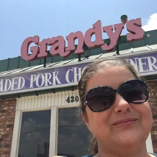 a woman standing in front of a restaurant