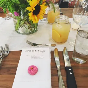 a table setting with a donut and a glass of water