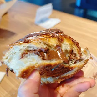 a hand holding a pastry