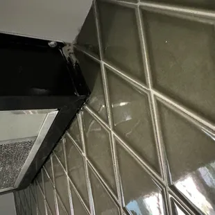 Black silicon instead of removing the air vent and properly tiling behind it.