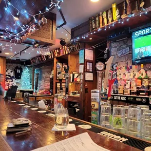 a bar with a large screen tv