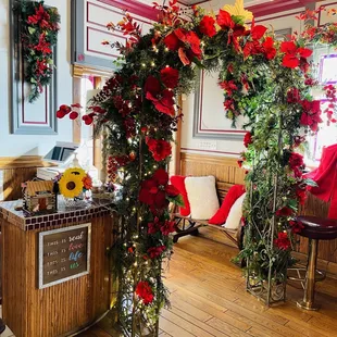 a decorated archway with red flowers