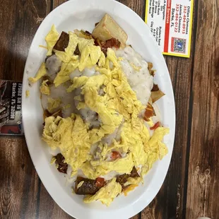Pan fries with bacon, scrambled eggs, tomatoes, onions and sausage gravy. Biscuits on the side (not pictured). Amazing!!