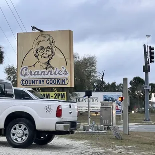 a truck parked in front of a sign