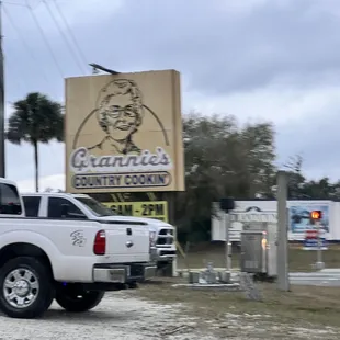 a truck parked in front of a restaurant