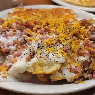 Pig Biscuit - four biscuits topped with ham, sausage, cheese, and lots of ground pepper added, and Hashbrowns completely shareable.