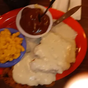Double portion chicken fried steak with macaroni and cheese and mashed potatoes and brown gravy