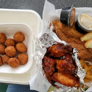 2 pieces of fish, 4 wings, onion rings, hush puppies, and Kool-Aid