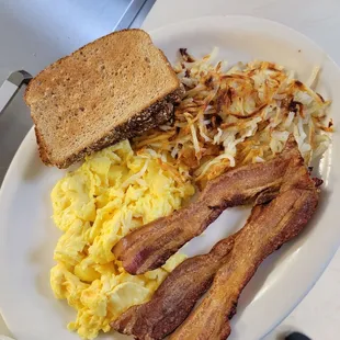 Granny's scrambled eggs, bacon, hash browns, and toast.
