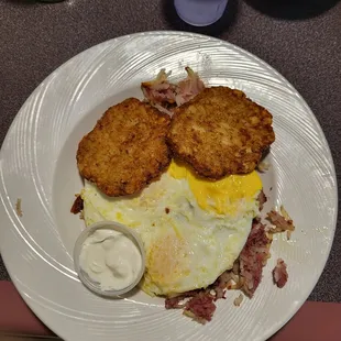 Corn beef hash topped with 3 eggs and fake potato pancakes.