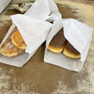 two donuts wrapped in wax paper