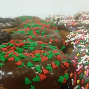 a variety of donuts with chocolate frosting and sprinkles