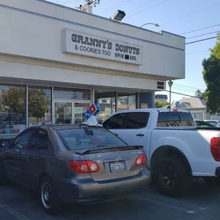 two cars parked in front of the store
