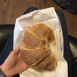 The gigantic cinnamon croissant pretty much fills the whole paper bag.