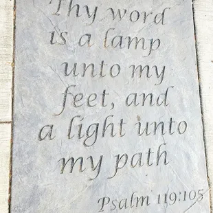 a stone plaque with a quote on it