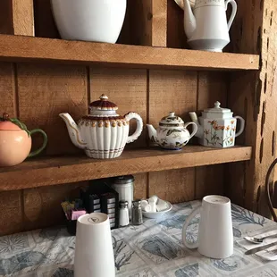 a table with teapots, cups, and plates