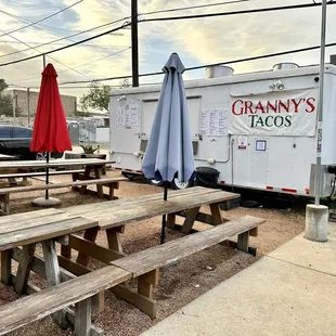 a food truck and picnic tables