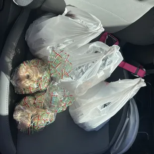 two bags of tamales in the back of a car