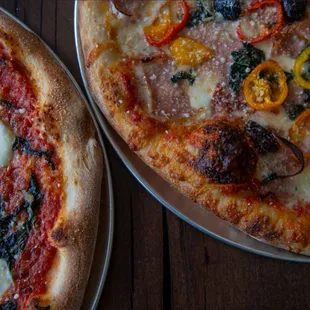 two pizzas on a table