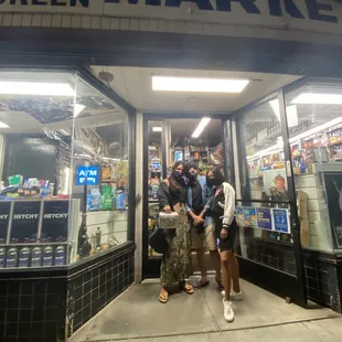 a group of people standing in front of a store