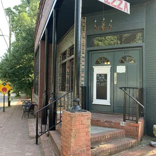 The entrance is on the corner with minimal signage.  Just that dangling &quot;Pizza&quot; sign alerts you that you are in the right place.