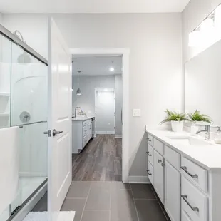 Bathrooms feature large showers, tile floors and granite.