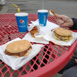 a man eating a hamburger and fries