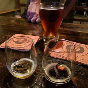 two glasses of beer on a wooden table