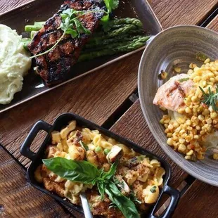 New York Steak (certified humane), Uptown Mac &amp; Cheese, and Salmon Filet (sustainable) with Cajun Corn Sauce