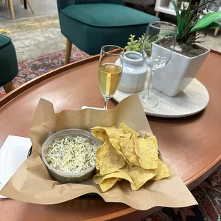 a tray of chips and a glass of wine