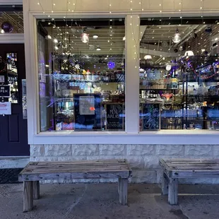 two benches in front of a store