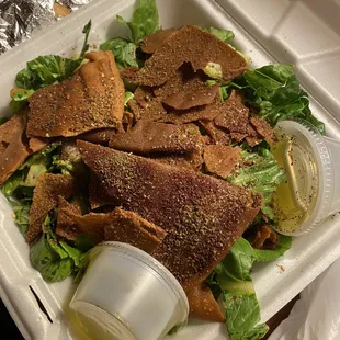 a salad in a styrofoam container