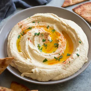 a bowl of hummusle and pita chips