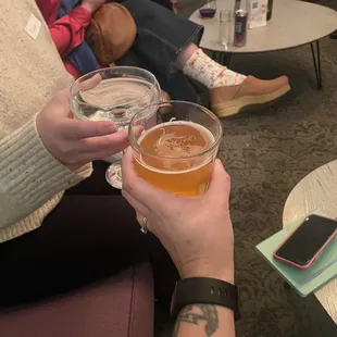 two people holding glasses of wine