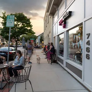 people sitting at tables outside