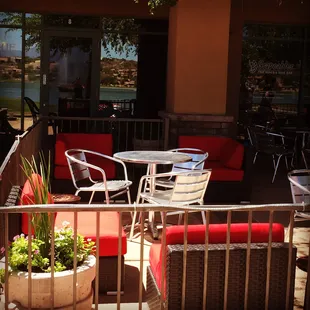 a patio with tables and chairs